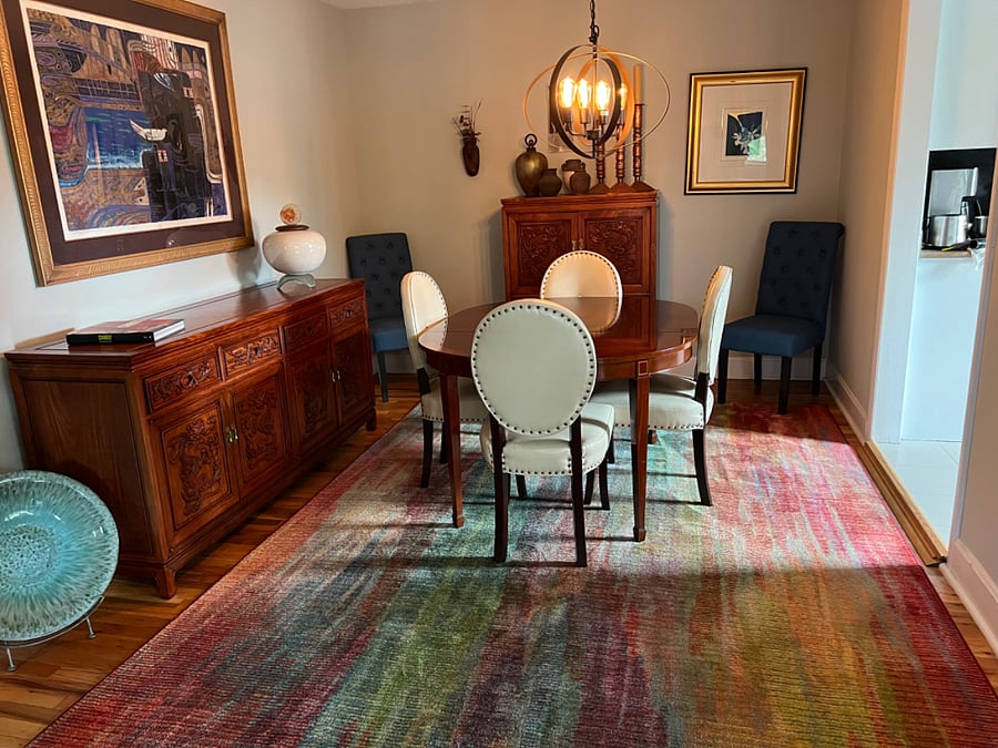 Dining room with one leaf in table comfortably seats 4. There is an extra leaf and additional seating for hosting guests for dinner or game nights. All leave out make adequate dining for 2 and makes room for a desk/work space.