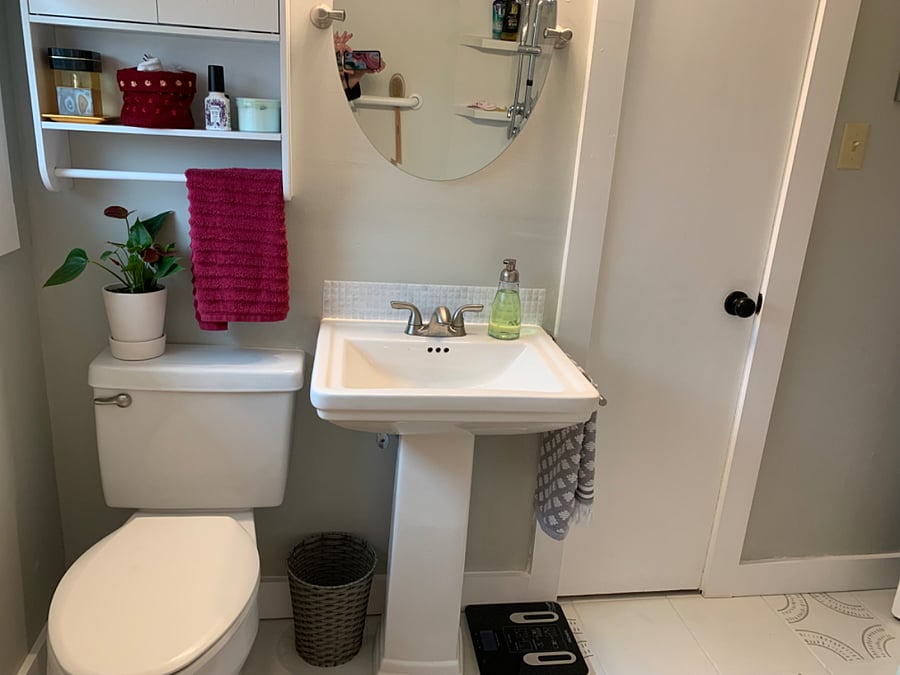 Pedestal sink, handy wall storage and a multi-shelved closet with hamper provided.