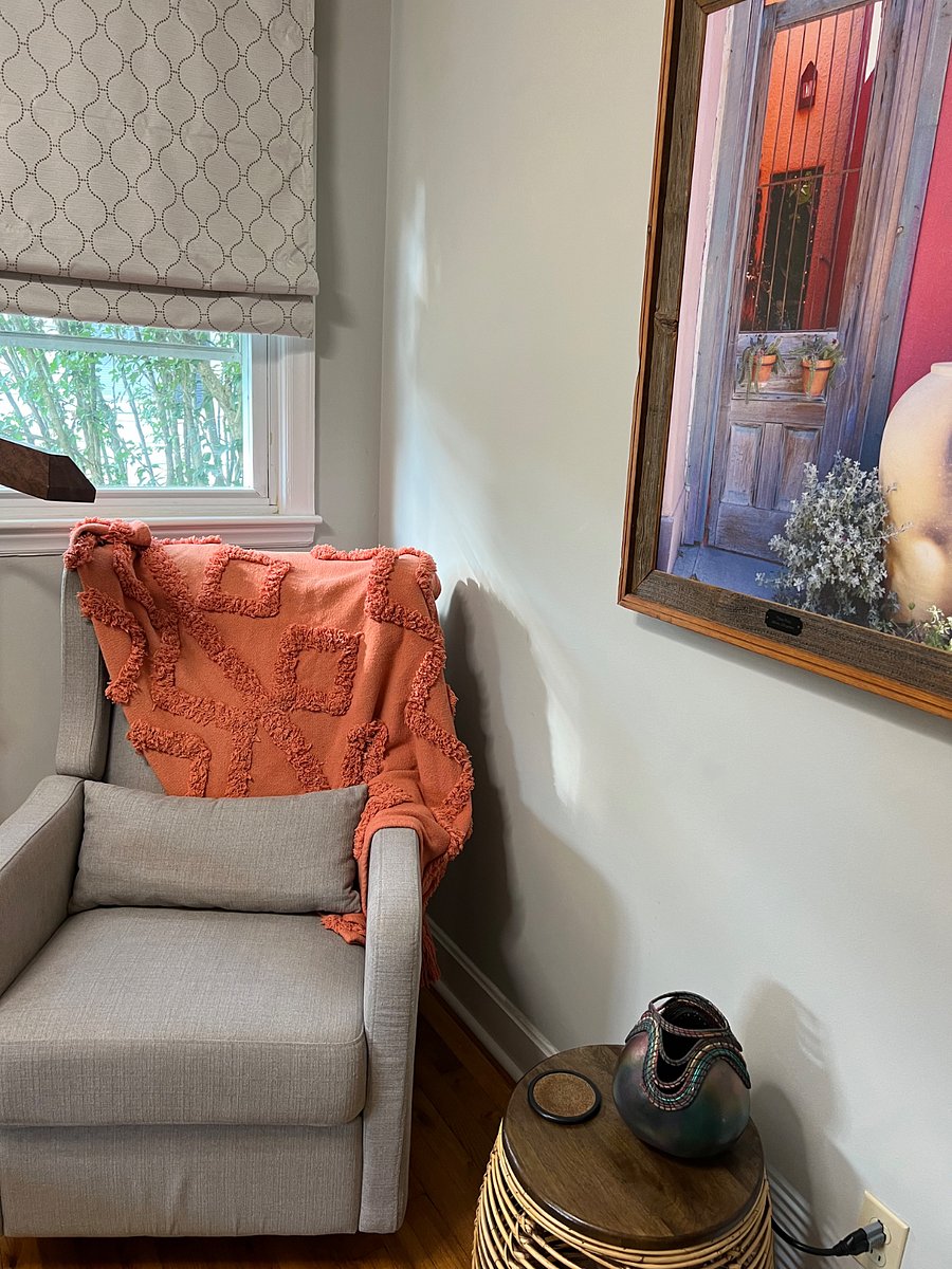 Swivel reclining rocker in this bedroom next to a north-facing windows makes a great reading spot.