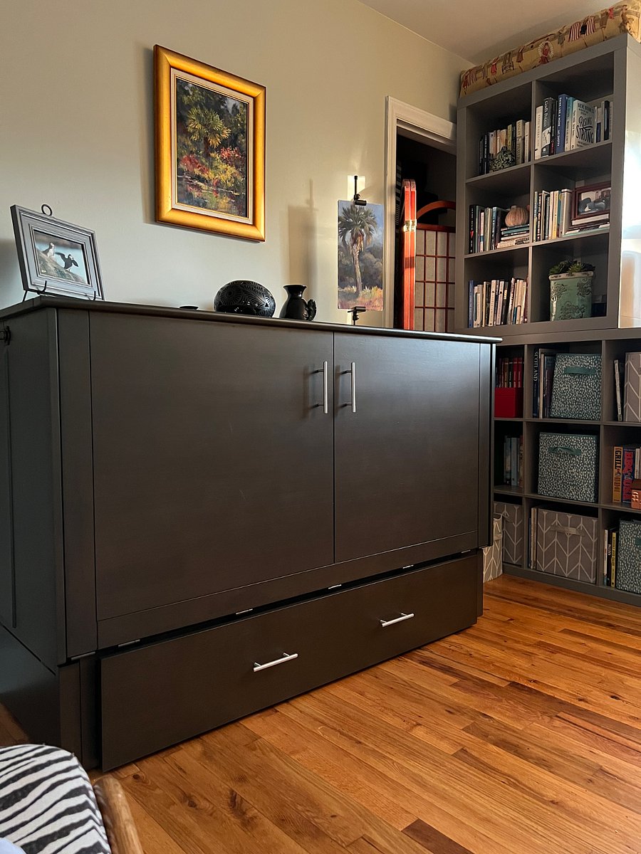 Second bedroom with cabinet bed closed and room set up for office, reading space, etc, when a second bedroom is not required.