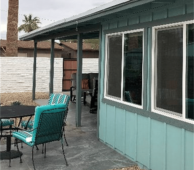 Unique to have a sun room with a guesthouse. Wrought iron outdoor patio table with four chairs provided with cushions.