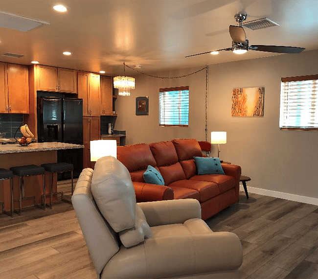 Top of the line leather furniture in an open floor plan concept. Electronic recliners on both ends of sofa and chair.
