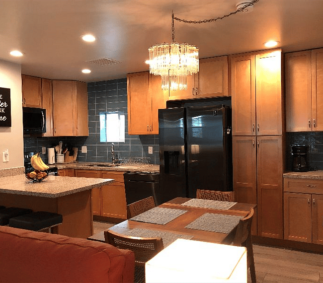 Large kitchen with full size side by side refrigerate with ice maker.