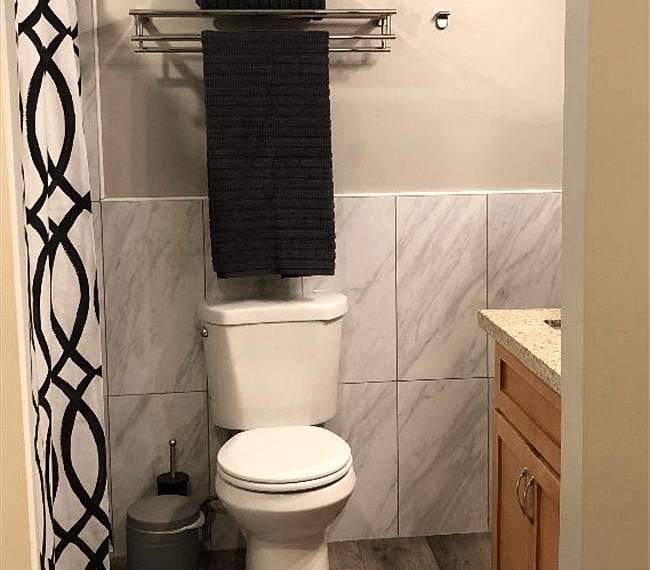 High toilet and double towel rack.