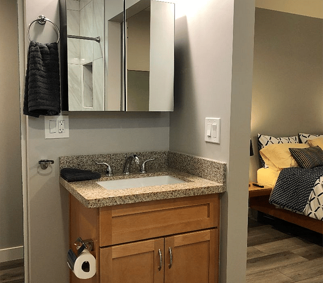 Bathroom with medicine cabinet and extra storage in master bedroom with cabinets for extra storage.