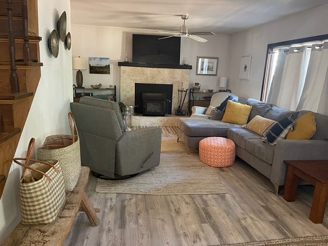 Beautiful living room with wood burning fireplace and large screen TV