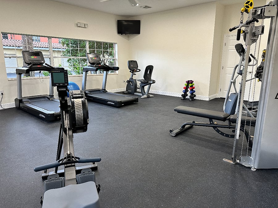 Fitness Room at the Clubhouse includes universal weight machines, treadmills, rowing and stair stepper machines, a bike and more. 