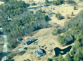Aerial view, rental building in red circle.