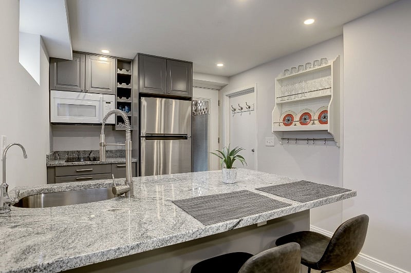 Kitchen, facing entry and laundry closet.