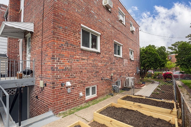 Side yard walkway to access apartment from front yard (stairs to apartment on on left side of photo).