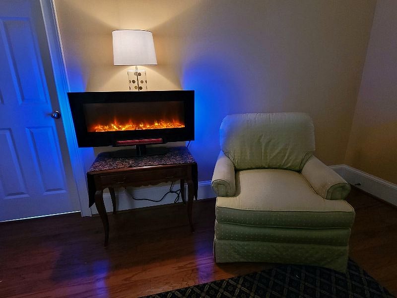 Bedroom remote fireplace with comfortable chair
