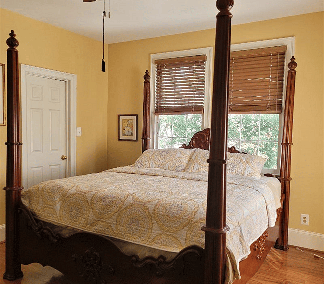King size cherry 4 poster bed. Jones Street is a quiet residential area of Savannah. . Pictured with summer bedding