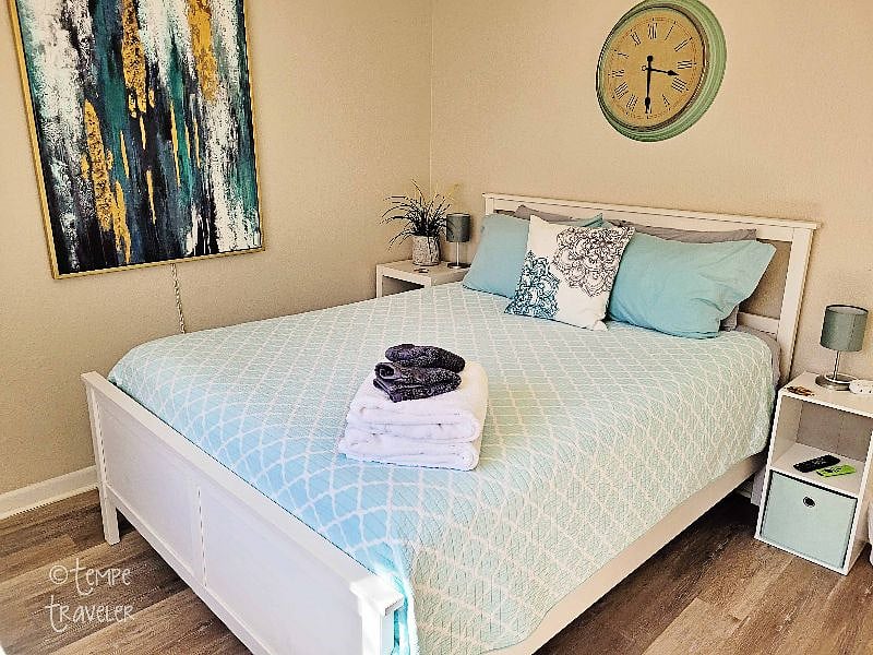 The 2nd bedroom has a Queen sized bed, a desk, a TV, and a bathroom in the hall that has a shower & tub.
