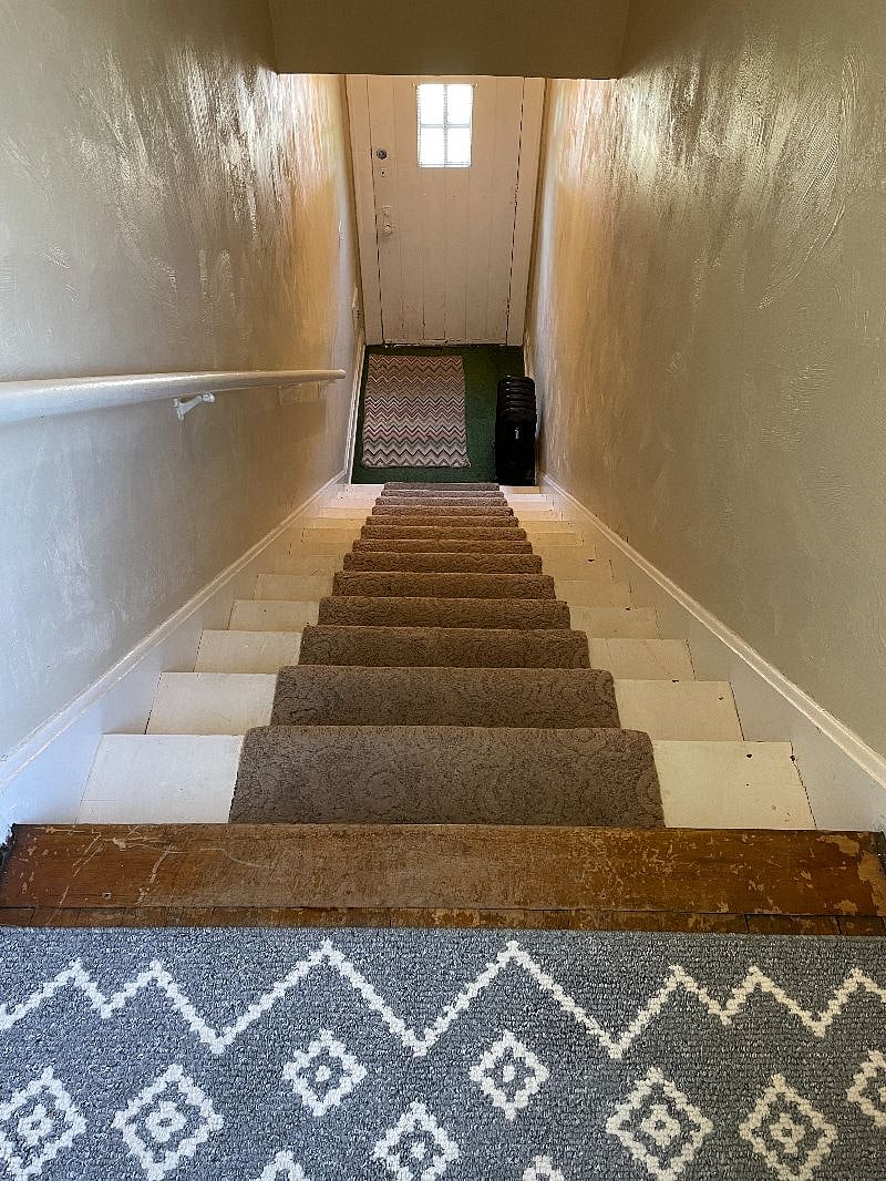 Private front entrance with stairs leading to this unit.