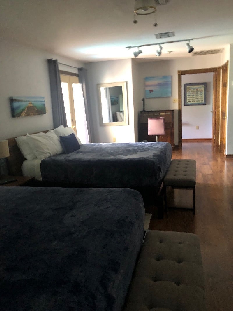 View of the SUPER large bedroom upstairs (facing large screen TV). A partition is available to add privacy between beds. Laundry room with a NEW Electrolux washer and dryer (is also upstairs).