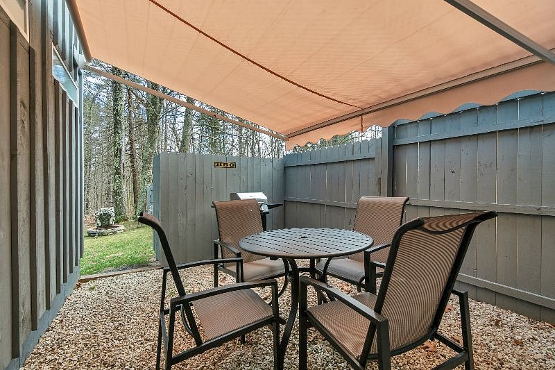 Private back patio with awning and BBQ.