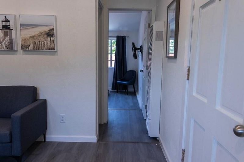 View from the front entrance through the hallway and into the bedroom.