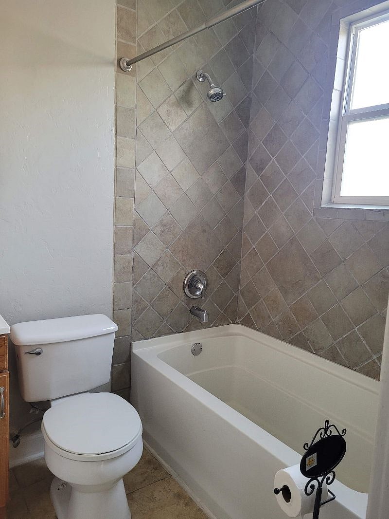 Full bathroom with closet shower/bath.