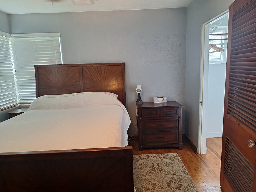Master bedroom with Queen bed, beautiful headboard and walk-in closet