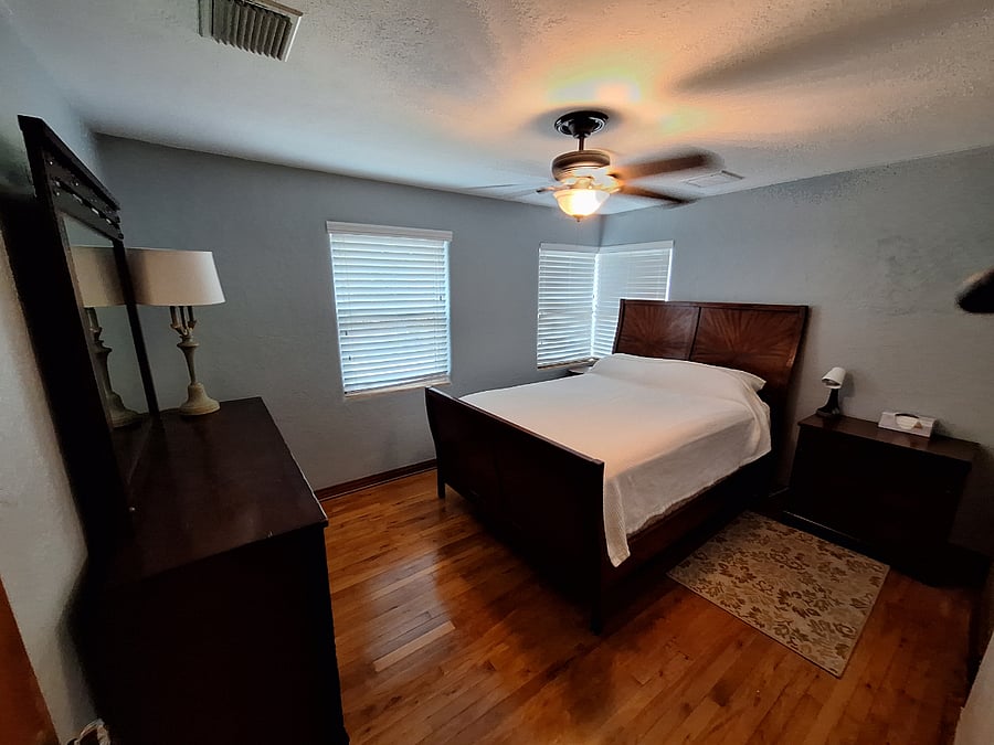 Master bedroom, queen bed and large dresser with mirror and walk-in closet.