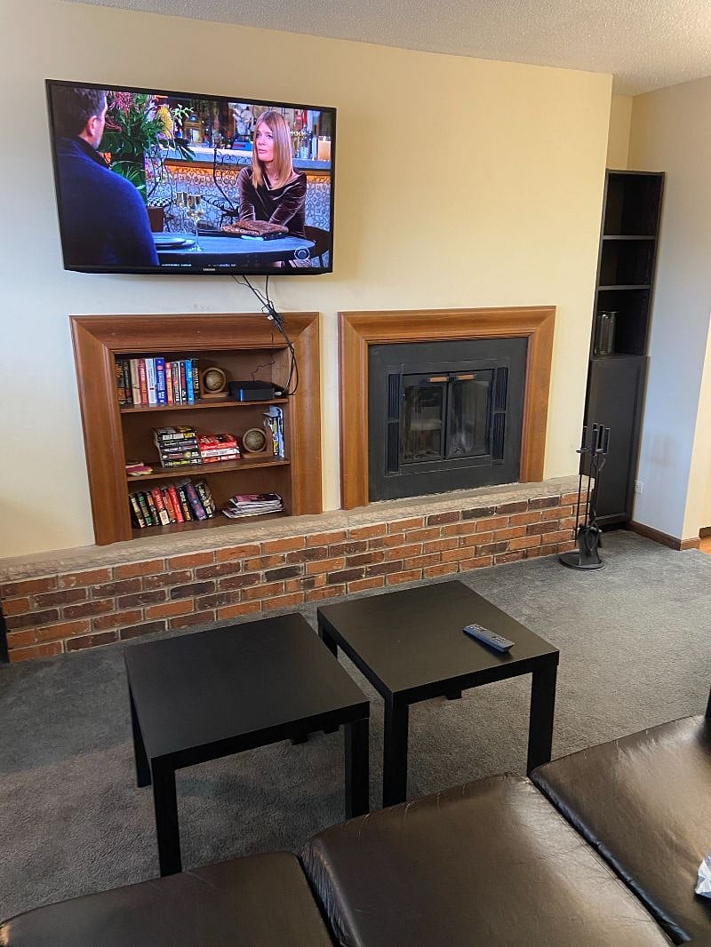 Chose the couch or easy chair to read or watch TV on the wall
