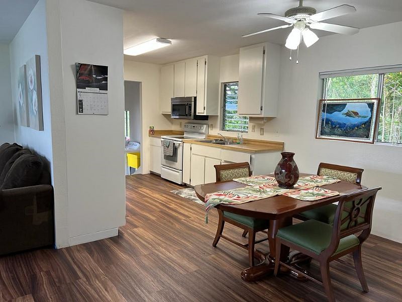Dining Room looking into family kitchen with a total of 7-matching chairs (1-chair in each bedroom)