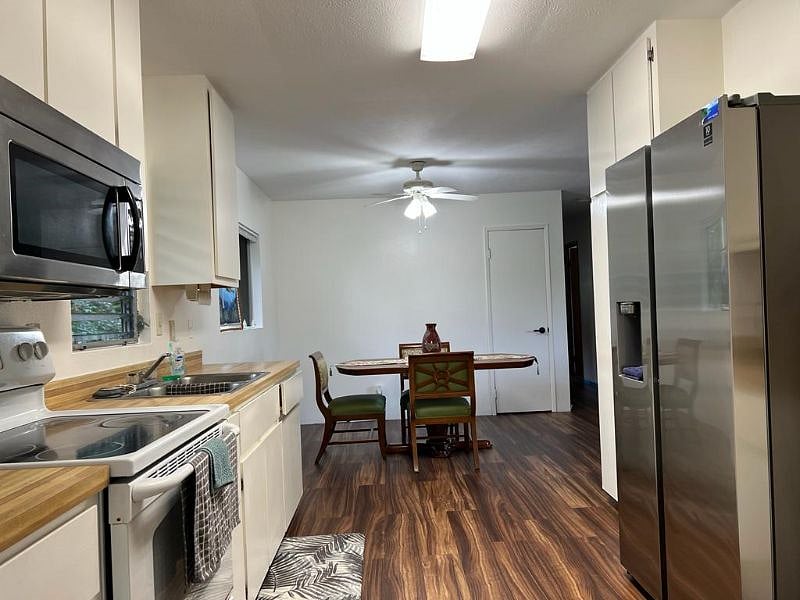 Your complete family kitchen with, new microwave oven, electric range/oven, new garbage disposal, and brand new vinyl flooring.
