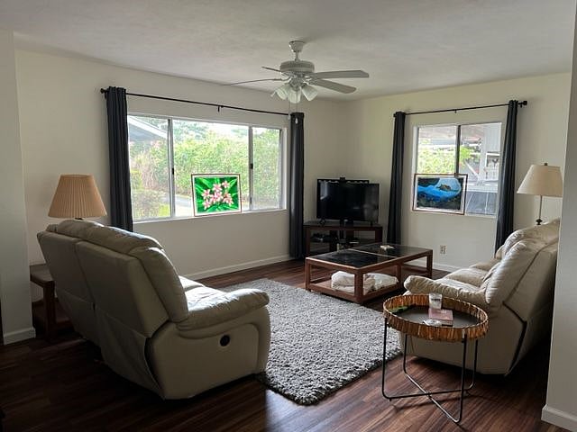 Living room with smart TV and new leather couch and love seat with electric recliners on the ends of both.
