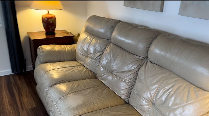 New leather couch with electric recliners on both ends.