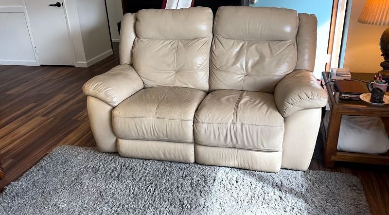 New leather loveseat with electric recliners on each end.