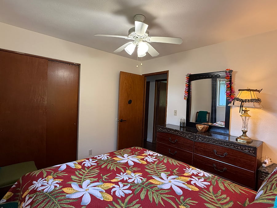 Bedroom #2 with 6-drawer dresser, night stand, 2-lamps, ceiling fan, large closet, and two windows for cool ocean breezes.
