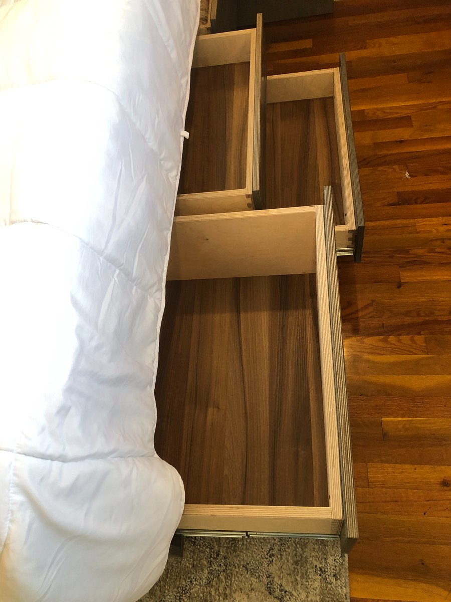 Queen bedroom has a custom made bed, complete with drawers for extra storage and fine craftsmanship. 