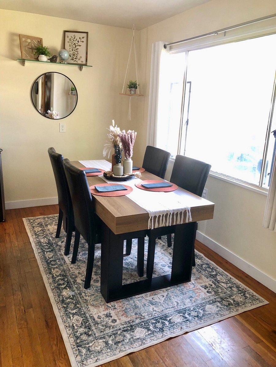 Dining table seats four comfortably, with an adjacent coffee and tea station for slow mornings or relaxed evenings.