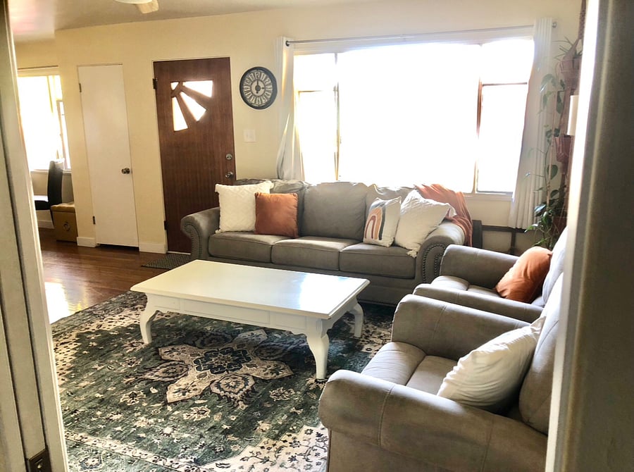 Comfortable seating, soft textures, and an electric fireplace create a calm place to unwind after a long day.