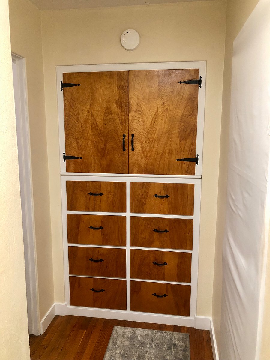 Deep hallway built-in complete with drawers and shelves. 