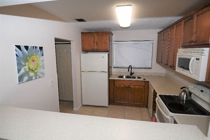 Large remodeled kitchen with Corian counter tops.
