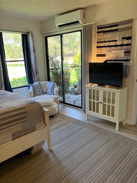 BEDROOM TV AND VIEW TO LANAI