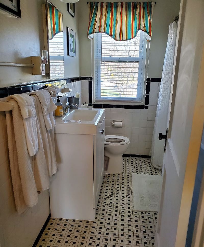 Tiled bathroom has shower/tub combo, sink /vanity with storage, toilet and large closet for toiletries and linens. Plenty of fresh new towels provided.