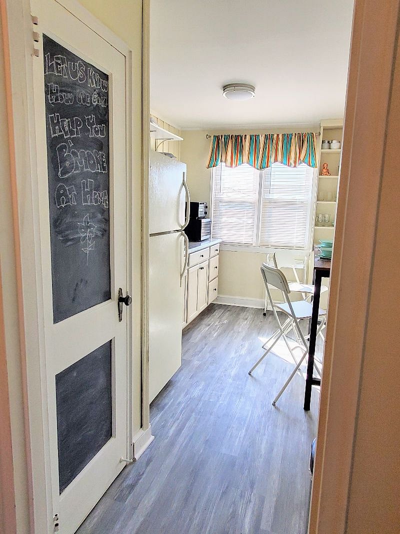 The kitchen gets lots of natural light and has a large pantry closet for storage. And a large refrigerator, sink, microwave and all the appliances you could need.