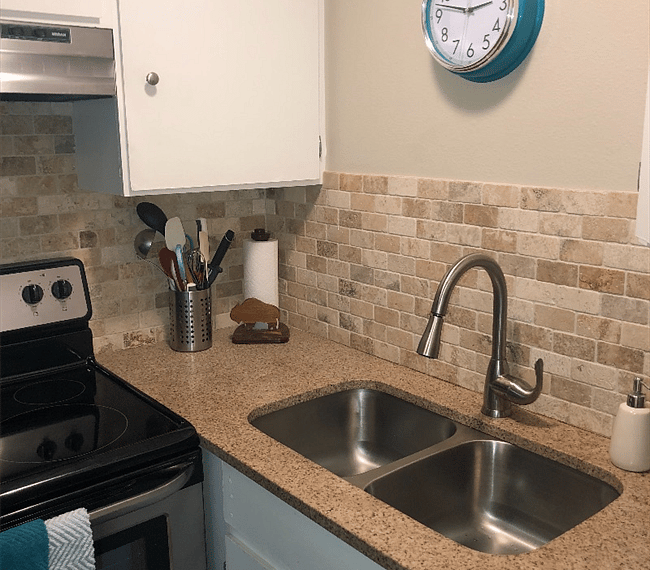 Extra large double stainless steel sink with goose neck faucet and all stainless steel appliances.