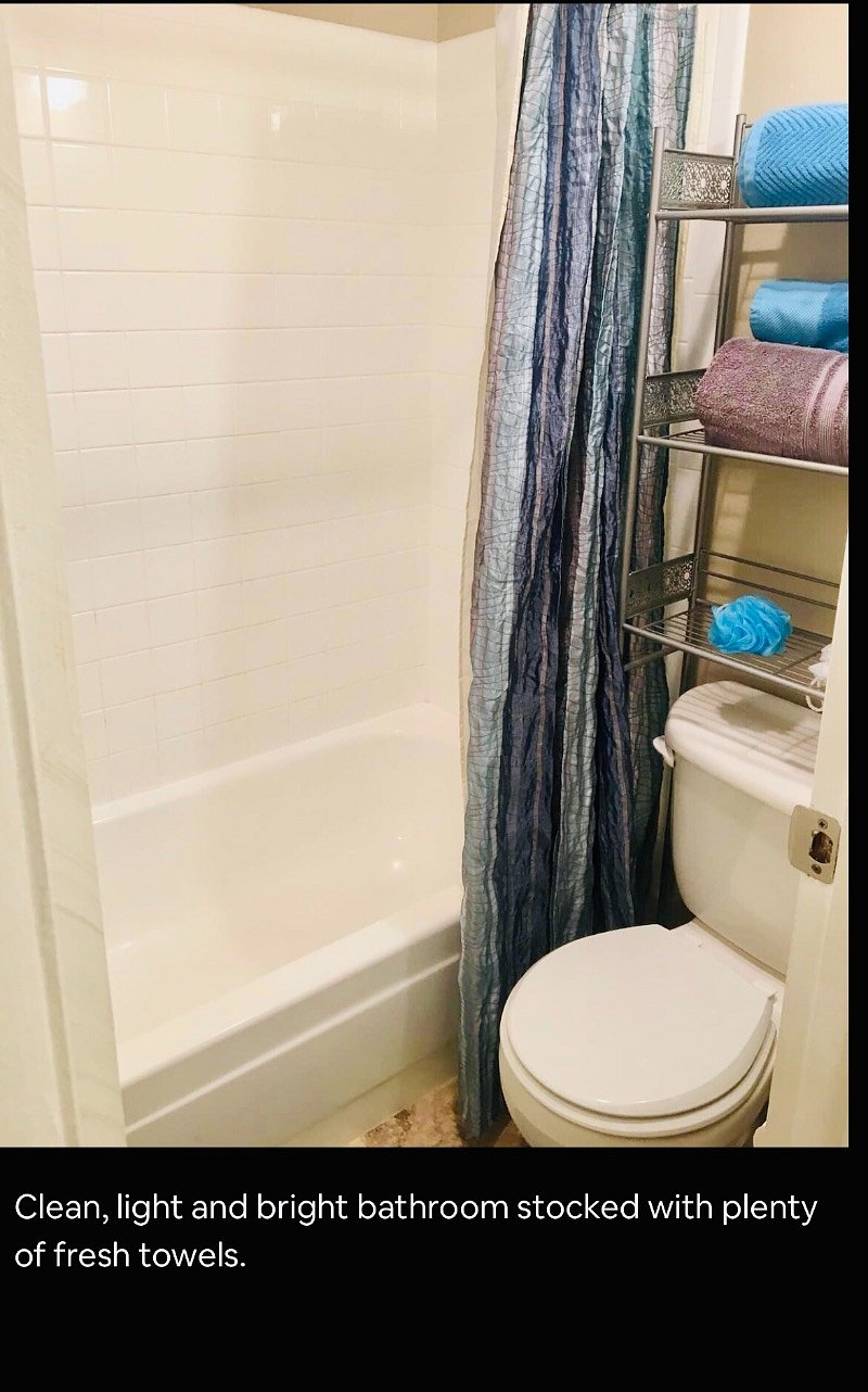 Clean, light and bright bathroom stocked with plenty of fresh towels.