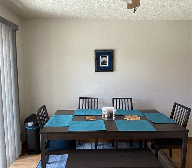 Dining space with sliding door to upper patio and grill