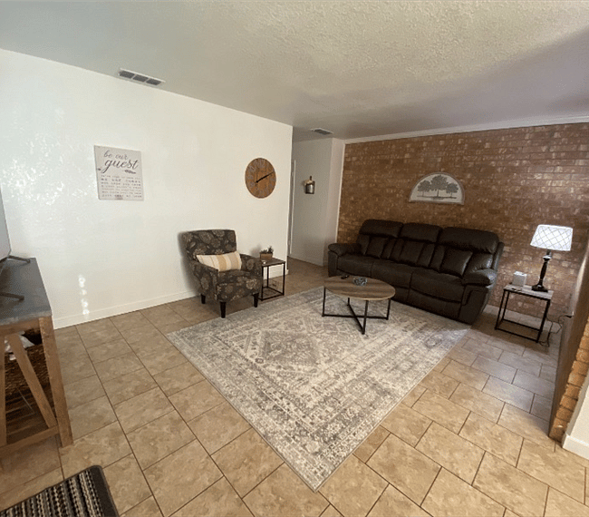 All of the living room furniture is new. There is a reclining microfiber couch and comfy chair with a 55" Smart TV.