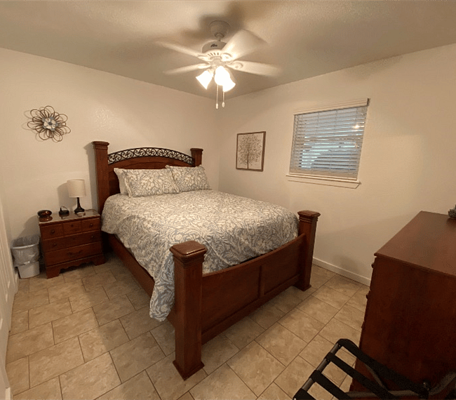 The master bedroom has a queen size bed with a pillow top mattress and a full size dresser.