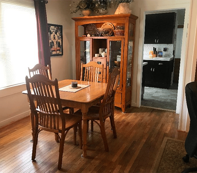 The dining area seats four. The dining table and chairs are solid oak made by artisans in Nashville, Ind. The hutch is stocked with dishes for your use.