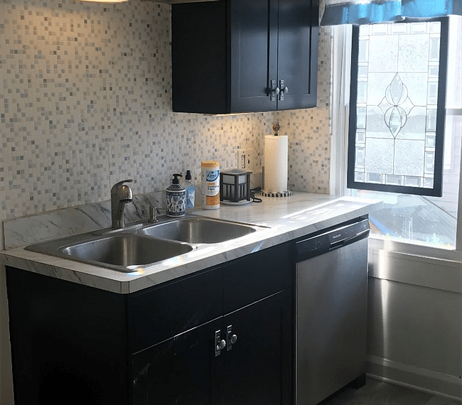 There is a stainless-steel sink in the kitchen along with a dishwasher.