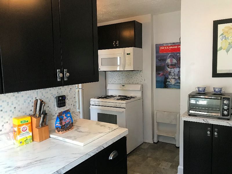 There is a washer and dryer in the unfinished basement, which you access through a door in the kitchen. There are cleaning supplies on a rack behind the door.