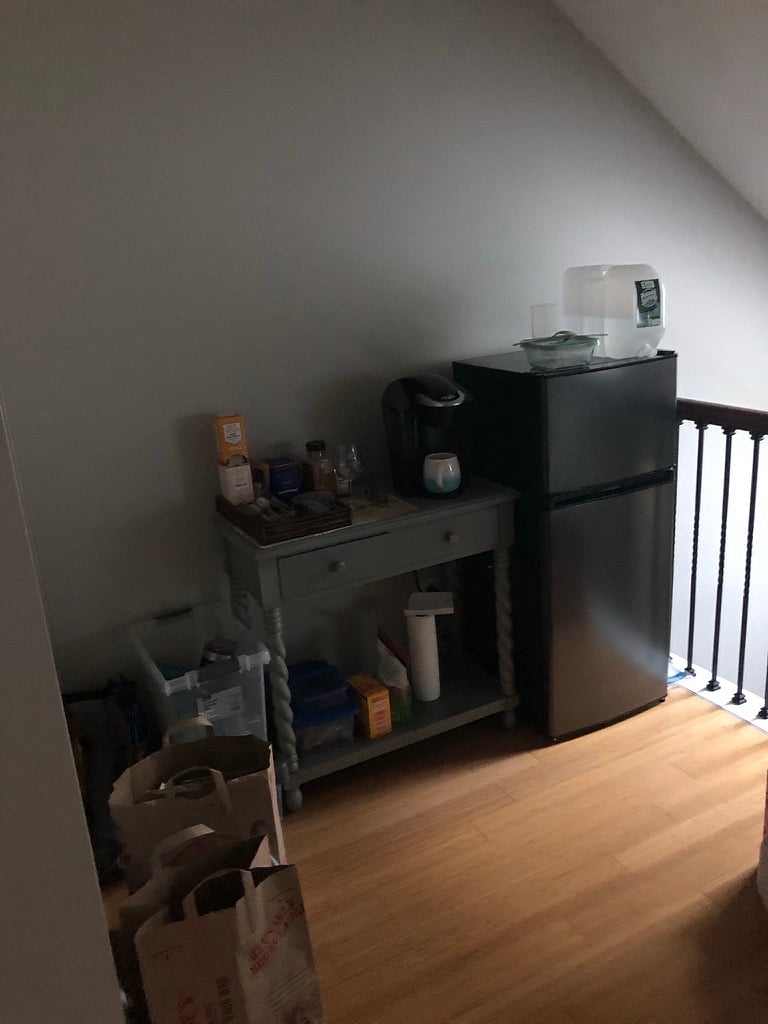 Full coffee bar area and small refrigerator in loft on second floor for tenant