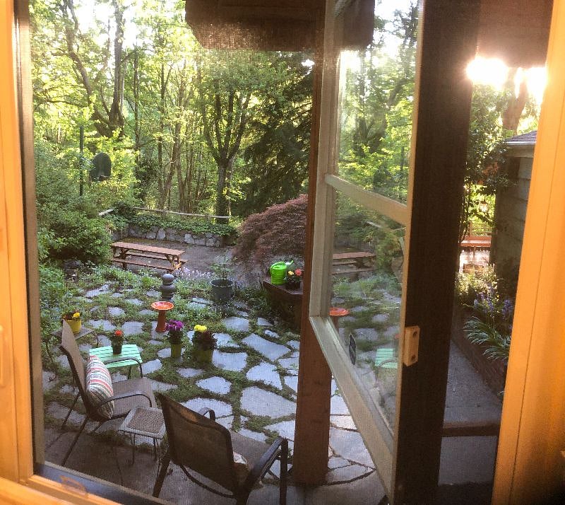 View of patio, basketball court and deck from your kitchen window.