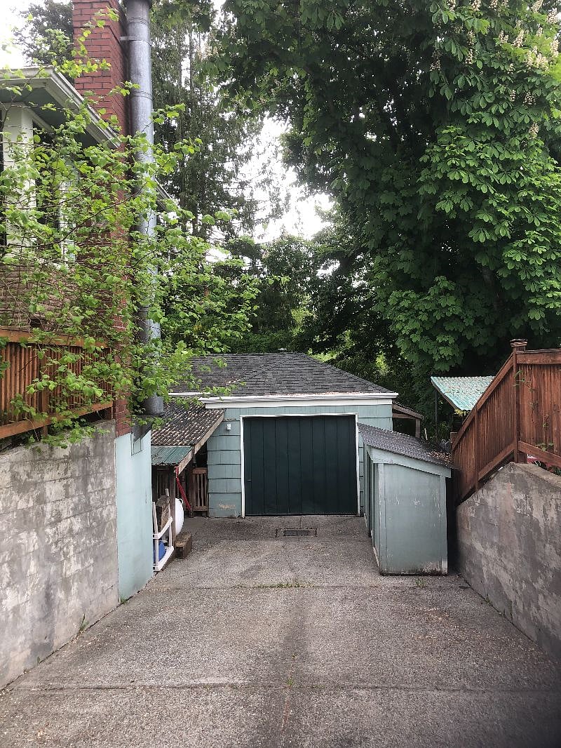 Off-street parking in driveway, next to gate and walkway to private rear entrance.